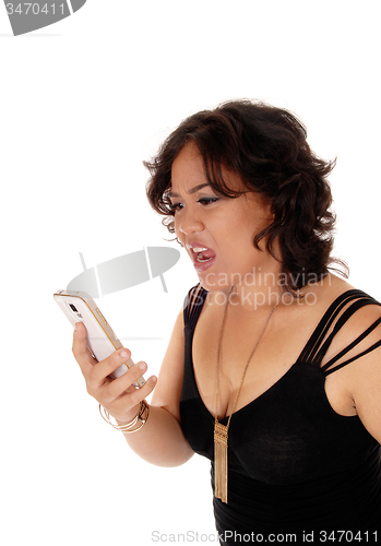 Image of Young woman shouting at her cell phone.