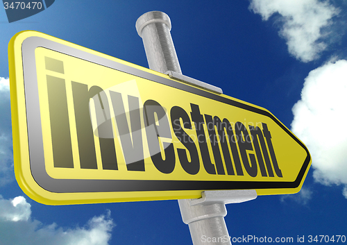 Image of Yellow road sign with investment word under blue sky