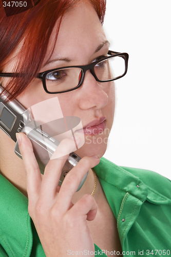 Image of Redheaded girl talking on a mobile phone