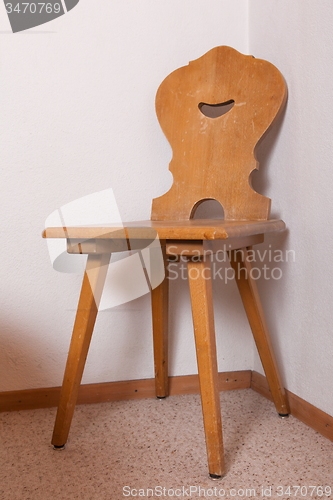 Image of Old wooden chair at the room corner of old house, Switzerland