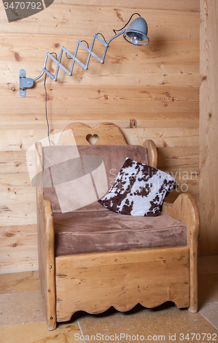 Image of Old electric lamp and wooden chair, Switzerland