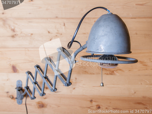 Image of Old electric lamp, harmonica, on a wooden wall, Switzerland