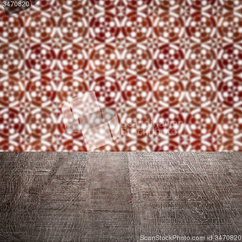 Image of Wood table top and blur vintage ceramic tile pattern wall