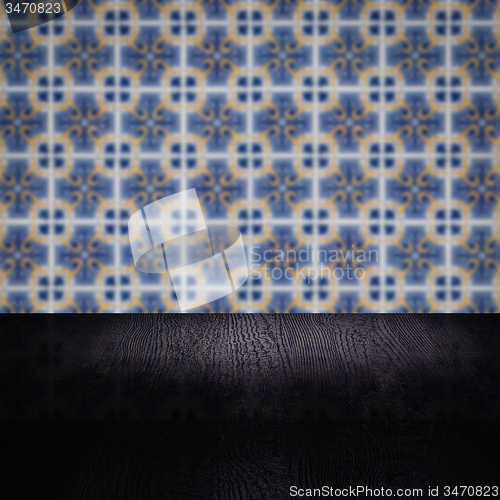 Image of Wood table top and blur vintage ceramic tile pattern wall