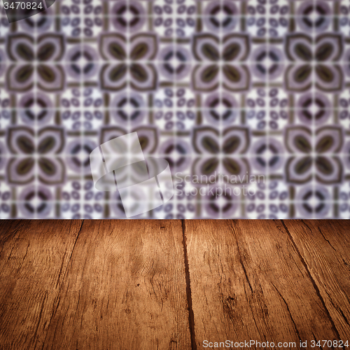 Image of Wood table top and blur vintage ceramic tile pattern wall