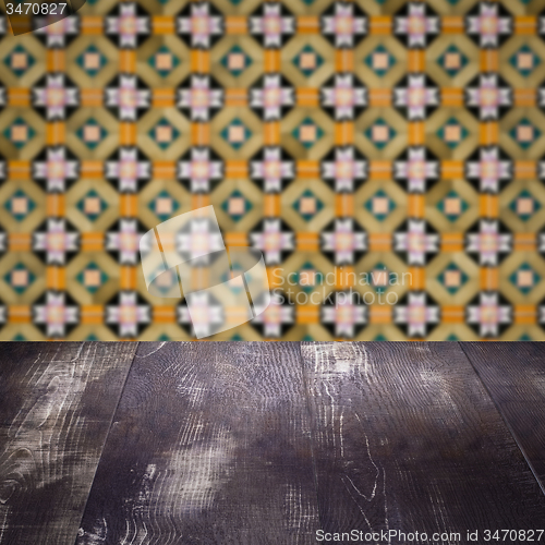 Image of Wood table top and blur vintage ceramic tile pattern wall