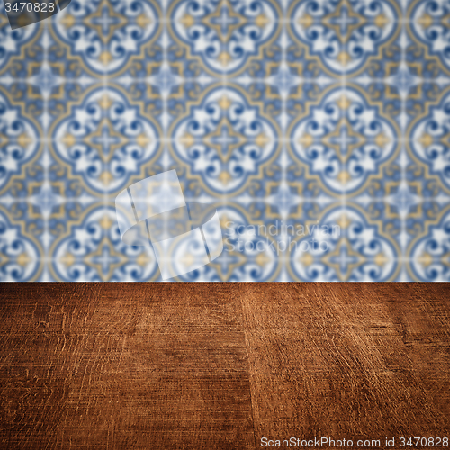 Image of Wood table top and blur vintage ceramic tile pattern wall
