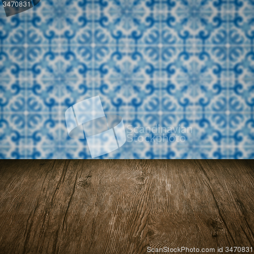 Image of Wood table top and blur vintage ceramic tile pattern wall