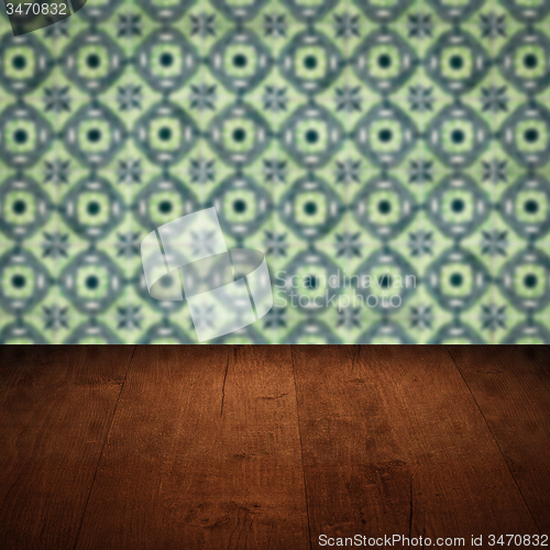 Image of Wood table top and blur vintage ceramic tile pattern wall
