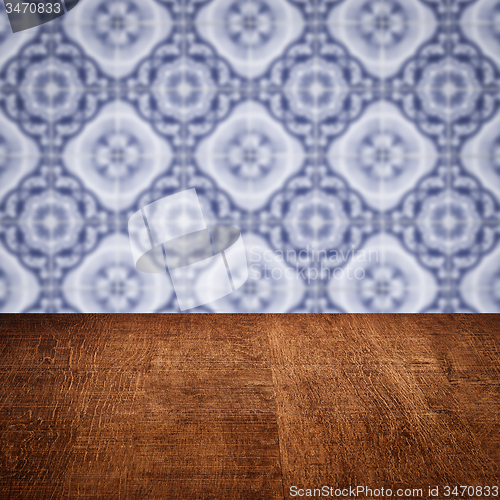 Image of Wood table top and blur vintage ceramic tile pattern wall