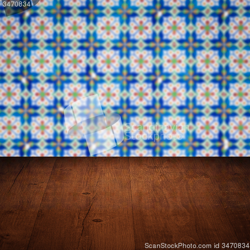 Image of Wood table top and blur vintage ceramic tile pattern wall