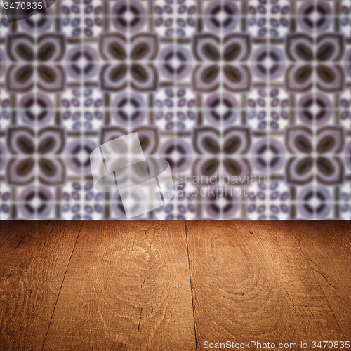 Image of Wood table top and blur vintage ceramic tile pattern wall