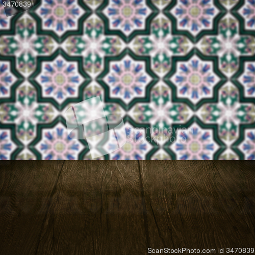 Image of Wood table top and blur vintage ceramic tile pattern wall