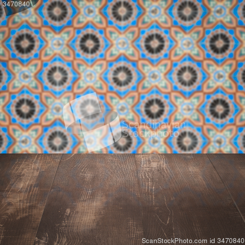 Image of Wood table top and blur vintage ceramic tile pattern wall