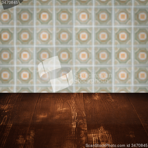 Image of Wood table top and blur vintage ceramic tile pattern wall
