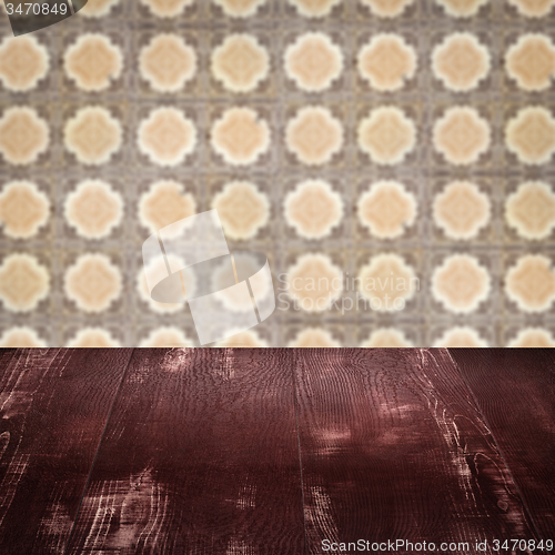 Image of Wood table top and blur vintage ceramic tile pattern wall