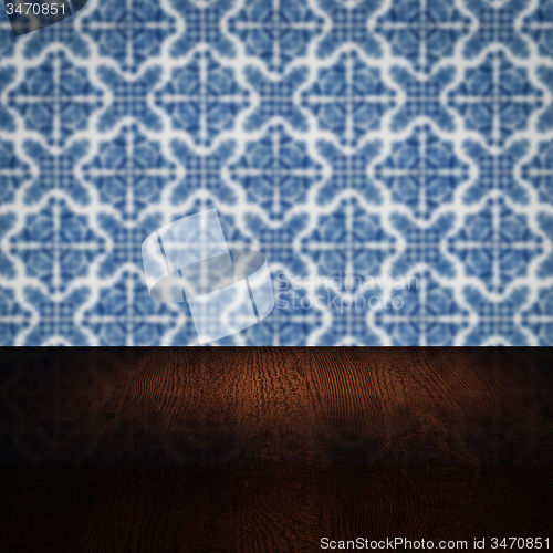 Image of Wood table top and blur vintage ceramic tile pattern wall