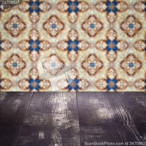 Image of Wood table top and blur vintage ceramic tile pattern wall