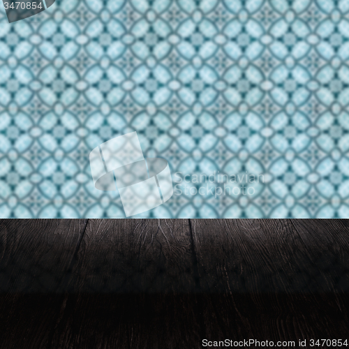 Image of Wood table top and blur vintage ceramic tile pattern wall