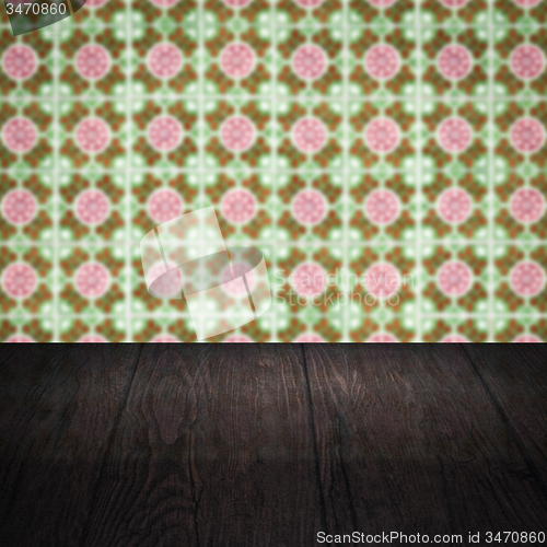 Image of Wood table top and blur vintage ceramic tile pattern wall
