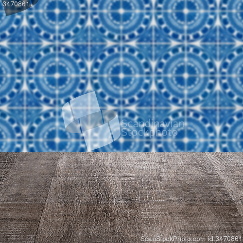 Image of Wood table top and blur vintage ceramic tile pattern wall