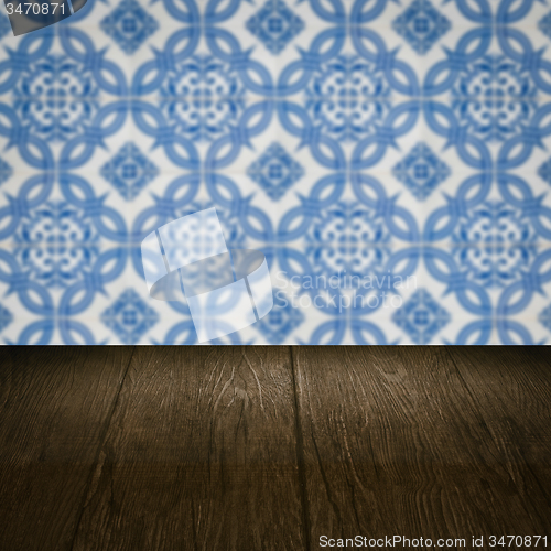 Image of Wood table top and blur vintage ceramic tile pattern wall