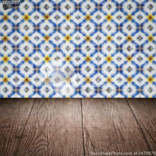Image of Wood table top and blur vintage ceramic tile pattern wall