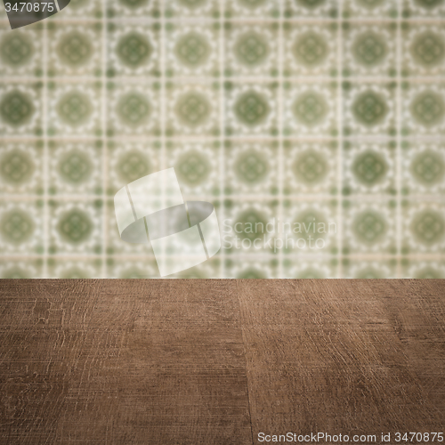 Image of Wood table top and blur vintage ceramic tile pattern wall