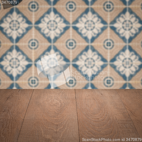 Image of Wood table top and blur vintage ceramic tile pattern wall