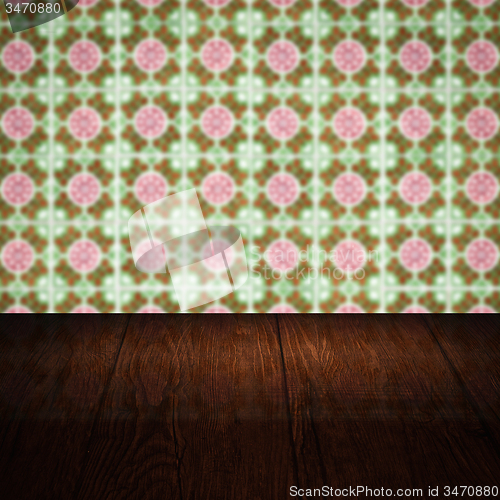 Image of Wood table top and blur vintage ceramic tile pattern wall