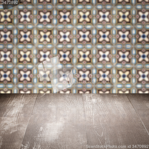 Image of Wood table top and blur vintage ceramic tile pattern wall