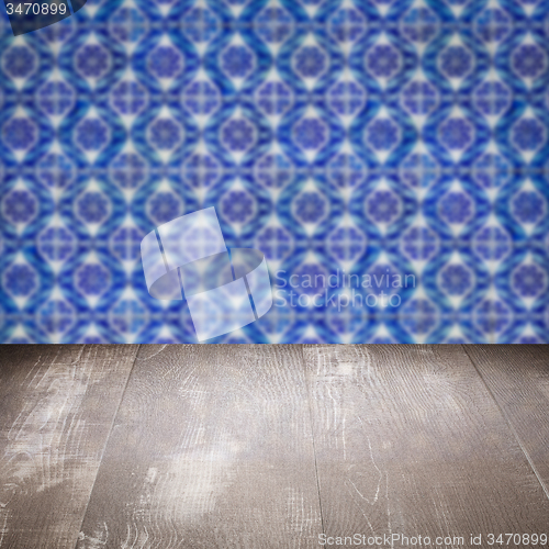 Image of Wood table top and blur vintage ceramic tile pattern wall