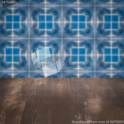 Image of Wood table top and blur vintage ceramic tile pattern wall
