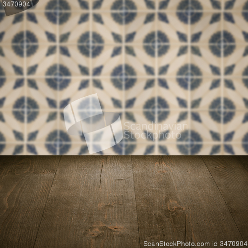 Image of Wood table top and blur vintage ceramic tile pattern wall