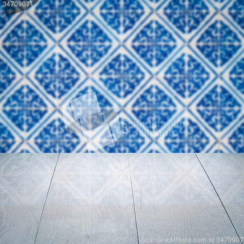 Image of Wood table top and blur vintage ceramic tile pattern wall