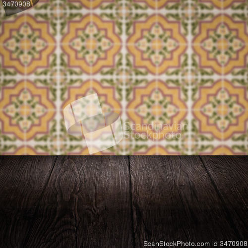 Image of Wood table top and blur vintage ceramic tile pattern wall