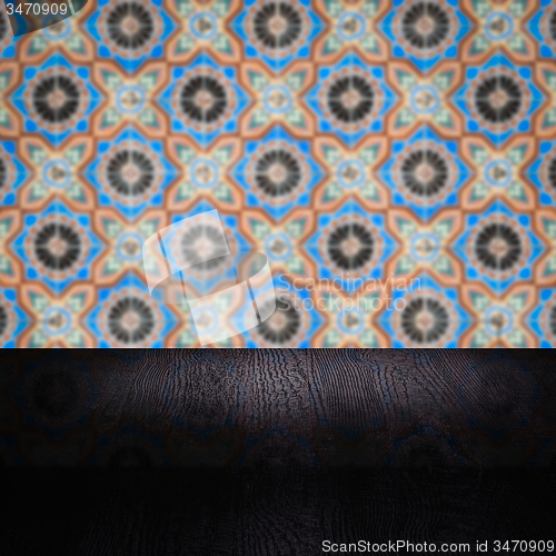 Image of Wood table top and blur vintage ceramic tile pattern wall