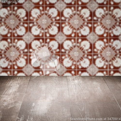 Image of Wood table top and blur vintage ceramic tile pattern wall