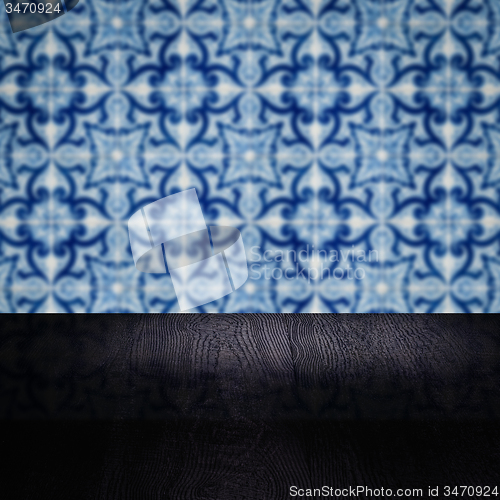 Image of Wood table top and blur vintage ceramic tile pattern wall