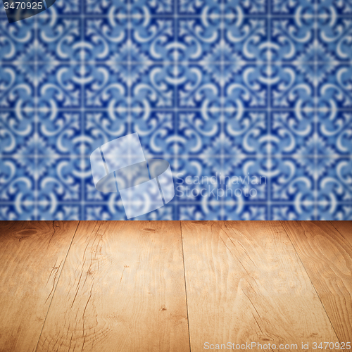 Image of Wood table top and blur vintage ceramic tile pattern wall