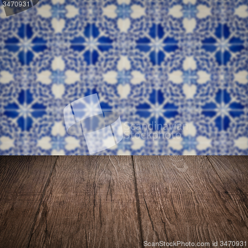 Image of Wood table top and blur vintage ceramic tile pattern wall