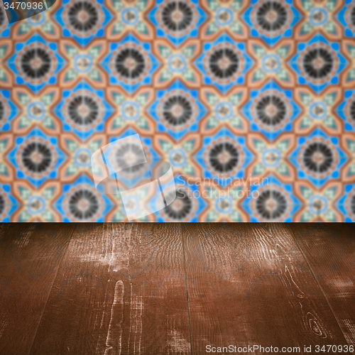 Image of Wood table top and blur vintage ceramic tile pattern wall
