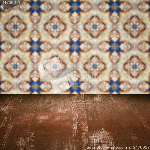 Image of Wood table top and blur vintage ceramic tile pattern wall