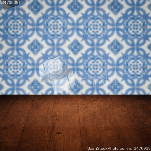 Image of Wood table top and blur vintage ceramic tile pattern wall