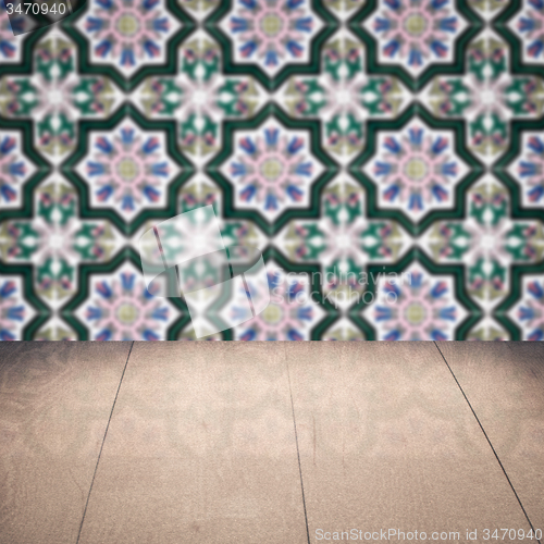 Image of Wood table top and blur vintage ceramic tile pattern wall