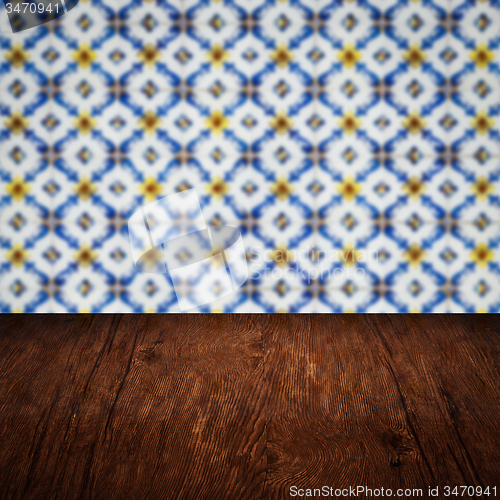 Image of Wood table top and blur vintage ceramic tile pattern wall