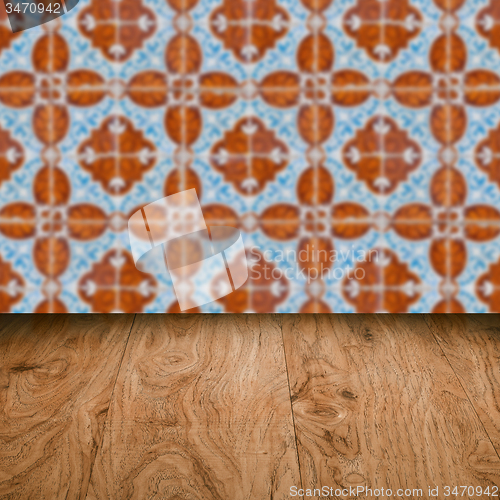 Image of Wood table top and blur vintage ceramic tile pattern wall