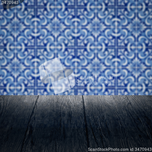 Image of Wood table top and blur vintage ceramic tile pattern wall