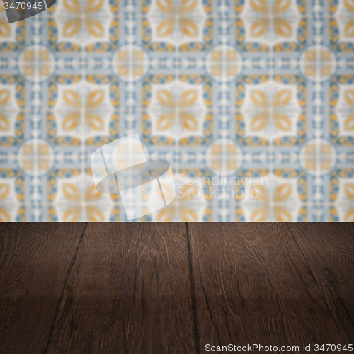 Image of Wood table top and blur vintage ceramic tile pattern wall