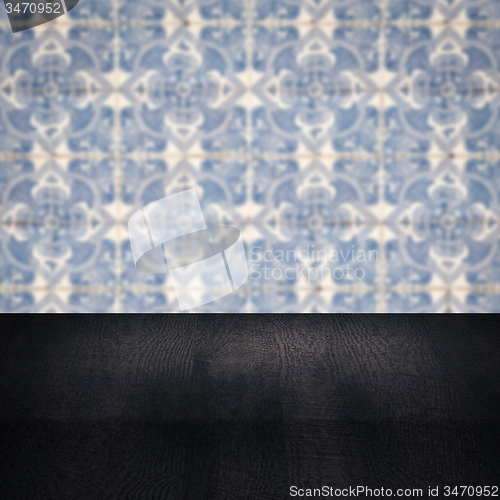 Image of Wood table top and blur vintage ceramic tile pattern wall